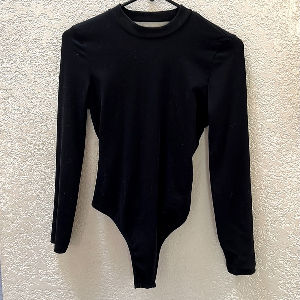 Open back, long sleeved bodysuit.
